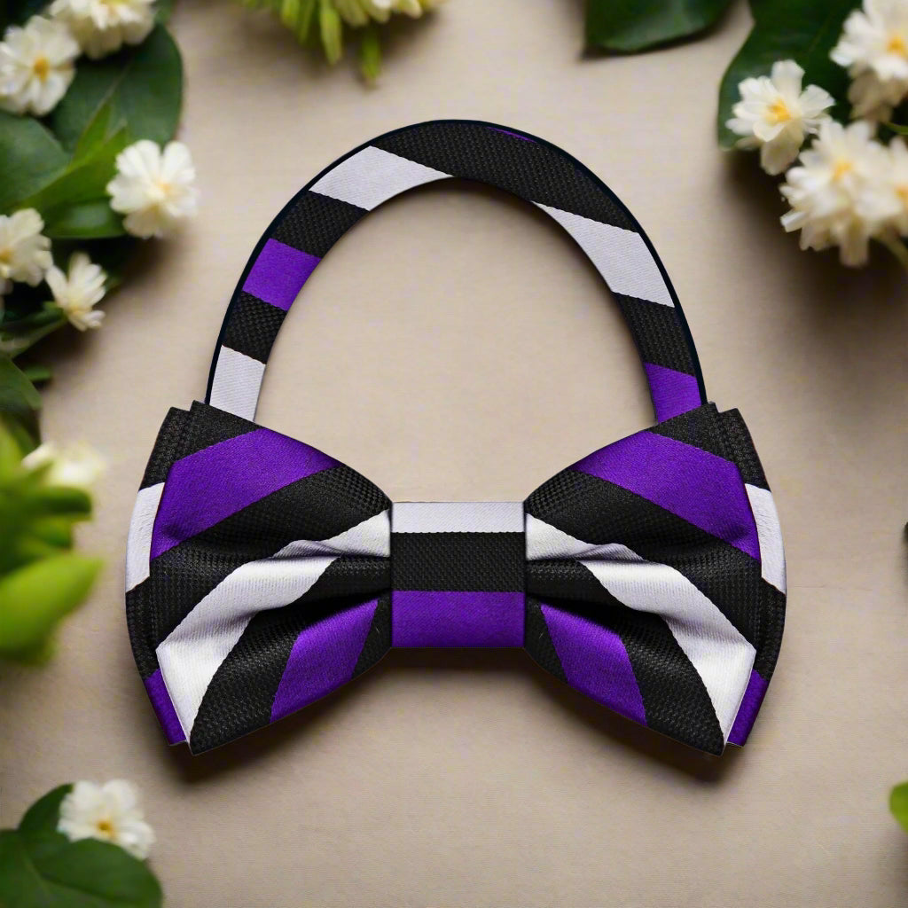Man adjusting his bow tie at a wedding, featuring a black and white stripe pattern for a classic look.