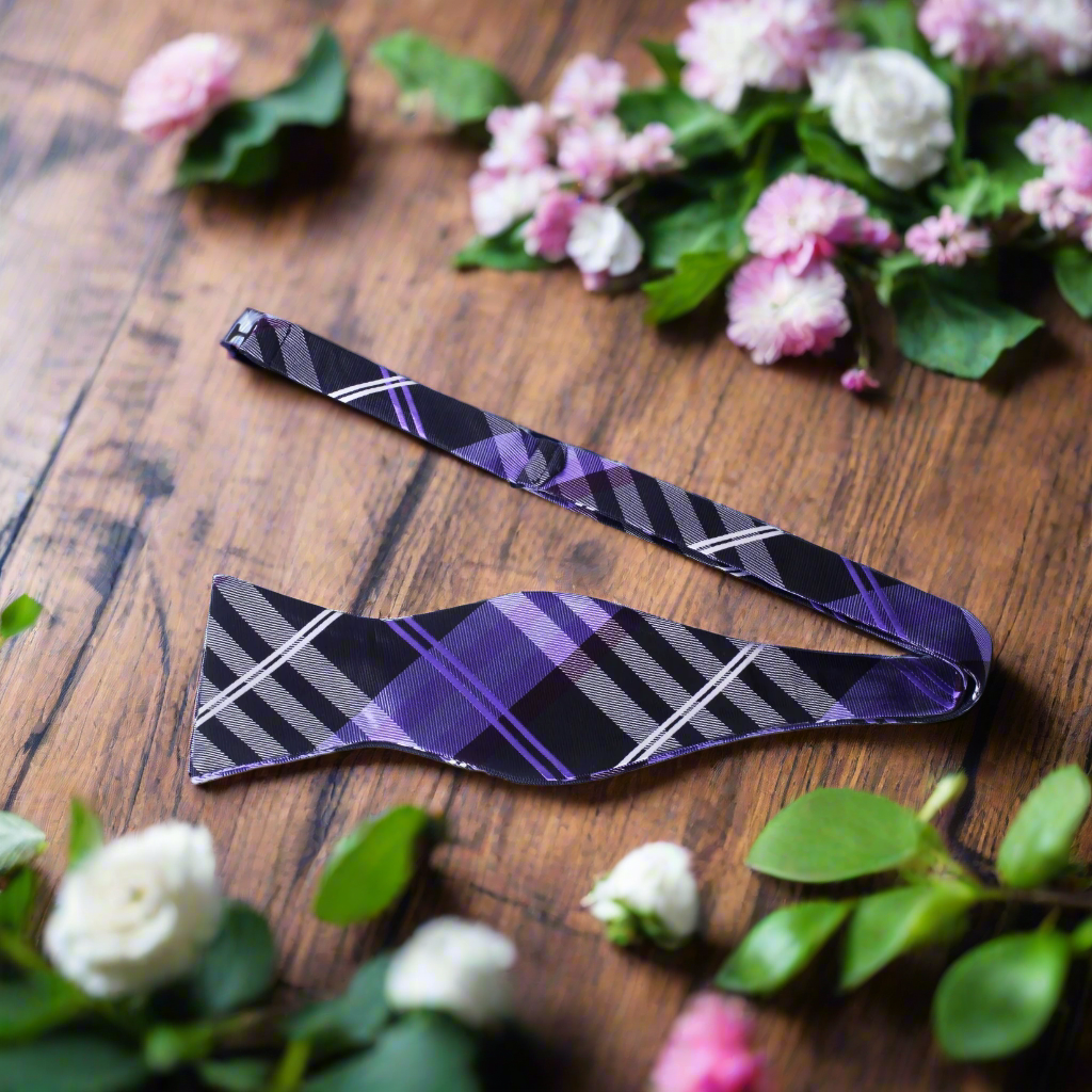 Group of friends wearing plaid bow ties at a casual wedding reception