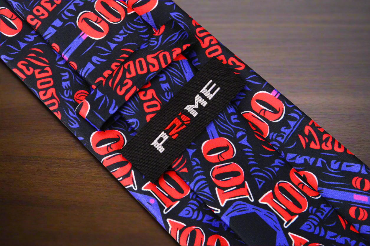 Close-up of the bold mens tie with green and yellow dollar bill designs against a black background, perfect for casino night.