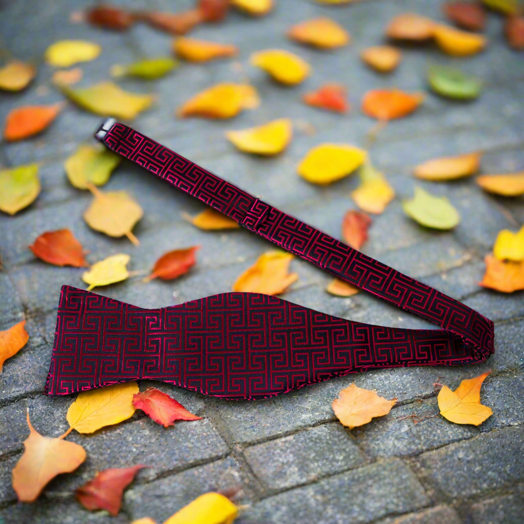 Close-up view of Egyptian silk self-tie bow tie set showcasing geometric design and colors.