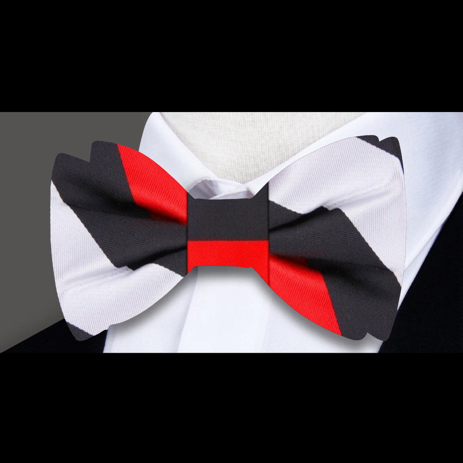 Stylish silk stripe bow tie paired with a crisp white dress shirt and navy blazer