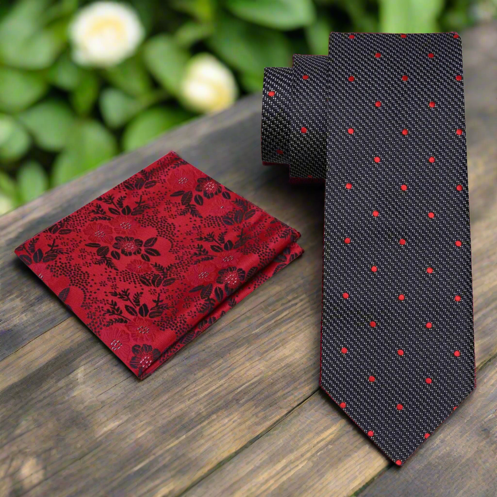 Full view of Blackwood polka dot tie and matching pocket square set laid flat on a charcoal suit