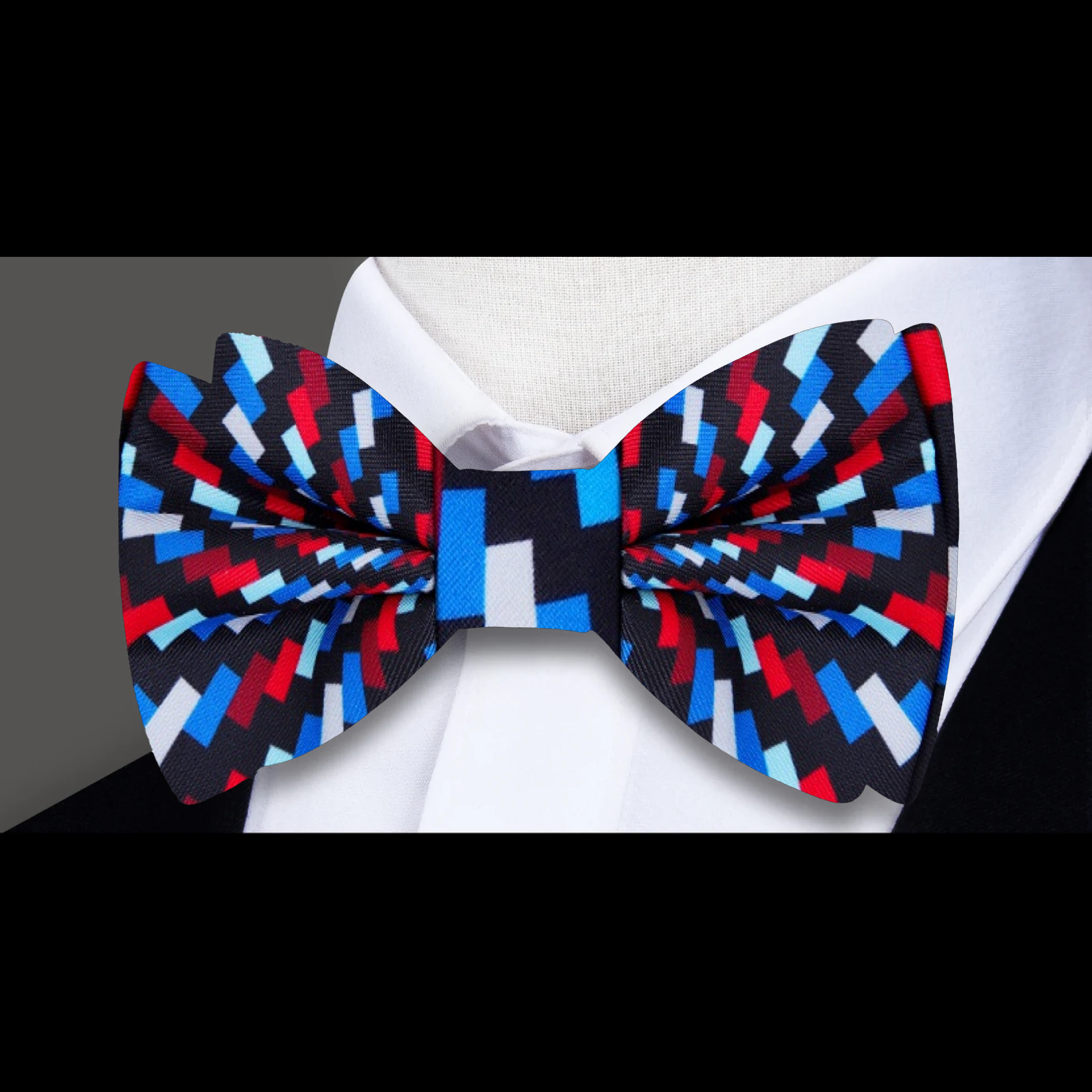 Styled with a matching pocket square, the self-tie bow tie worn with a crisp white shirt and navy suit.