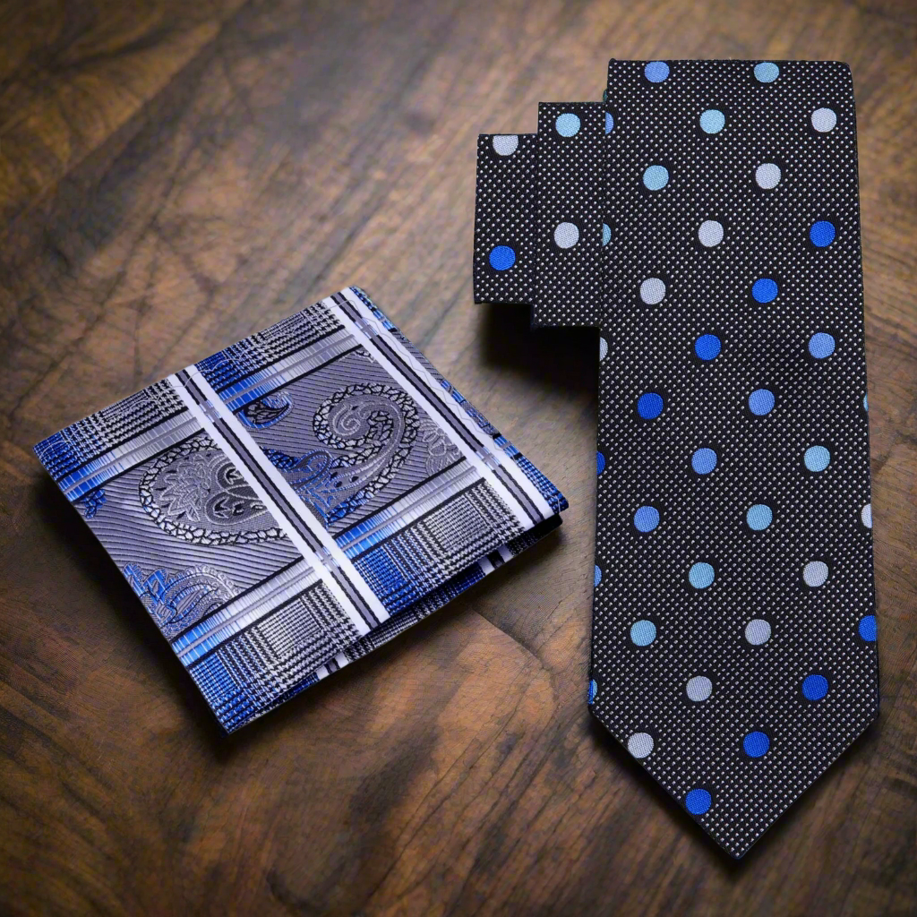 Elegant black and blue polka dot necktie displayed on a flat surface