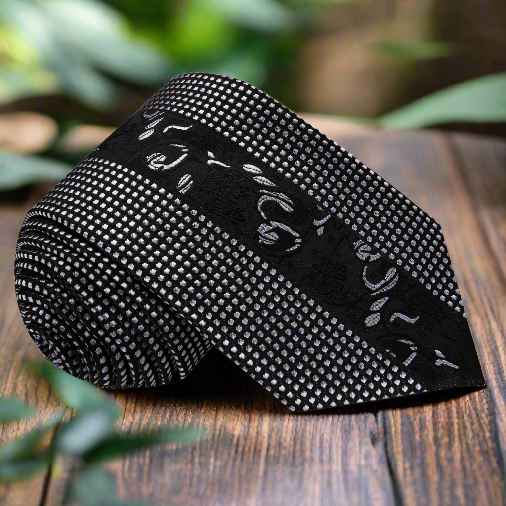 Close-up of black and silver silk necktie with floral design for formal occasions