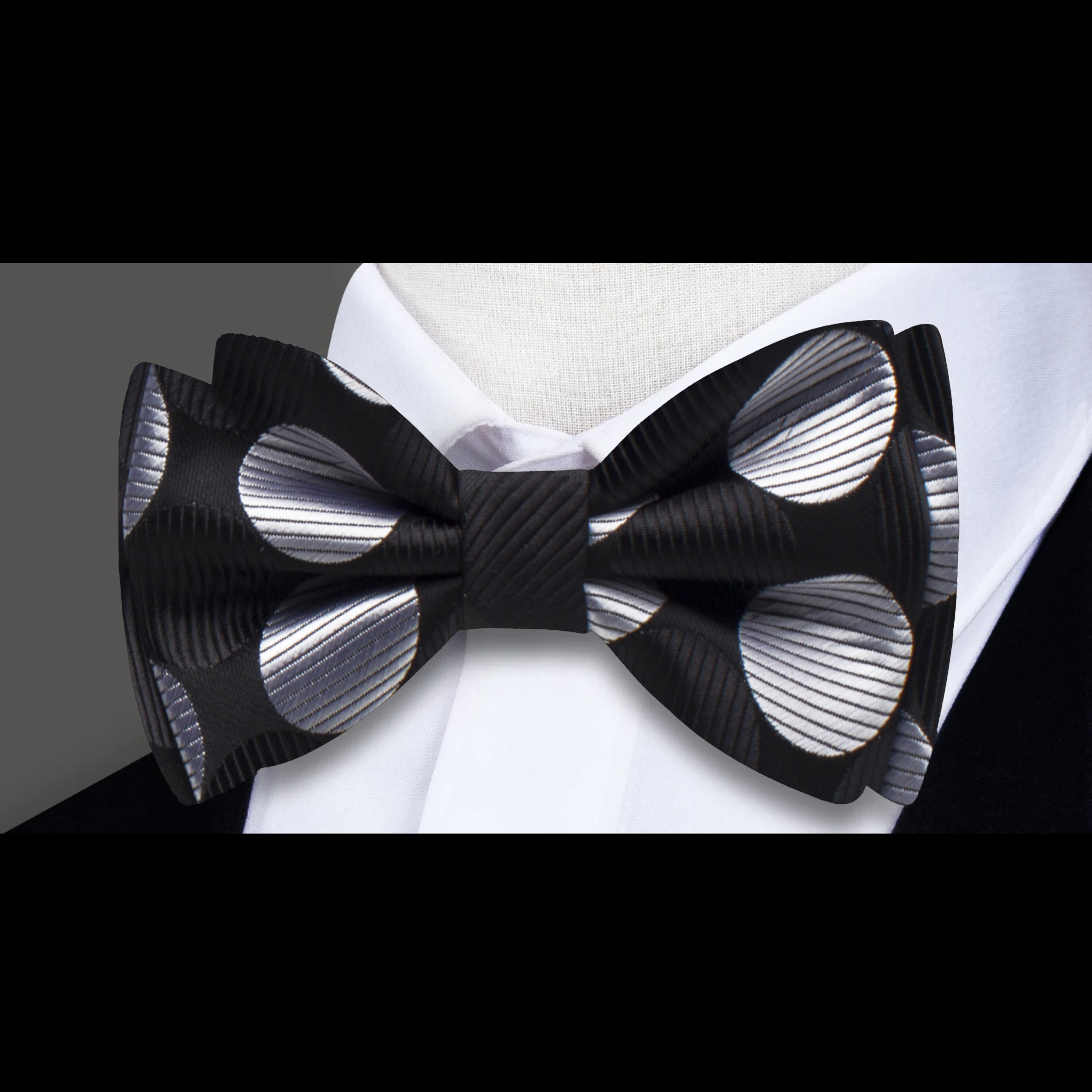 Close-up of a vibrant orange polka dot bow tie paired with a matching pocket square.
