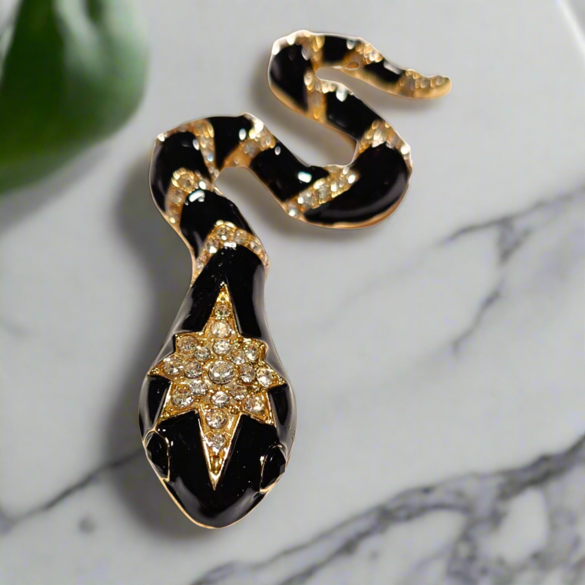 Styled image of the snake brooch on a tailored suit jacket, perfect for formal events.