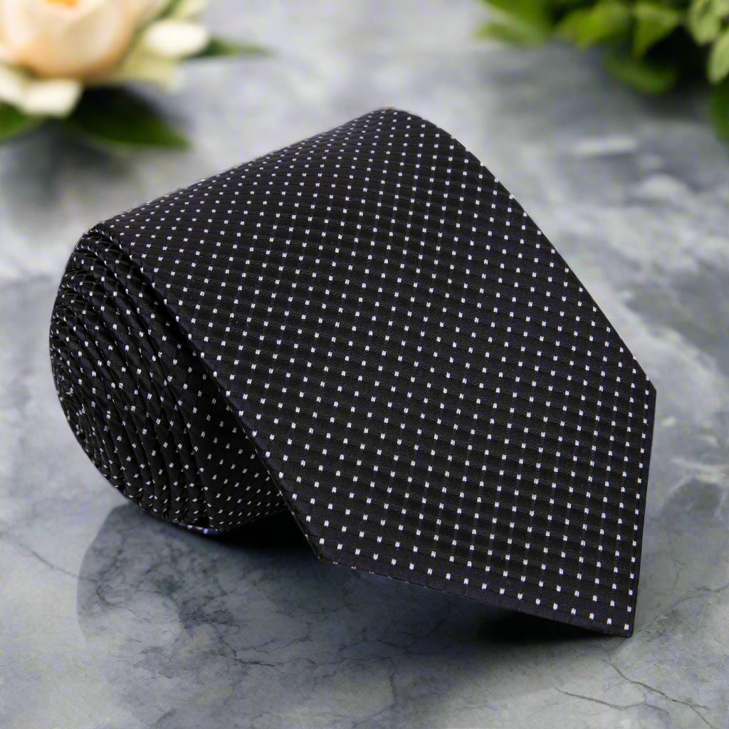 Elegant black silk tie featuring a geometric pattern, ideal for formal occasions.