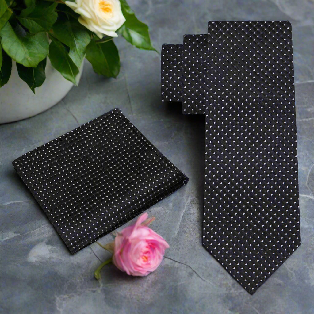 Elegant black silk tie featuring a geometric pattern, ideal for formal occasions.