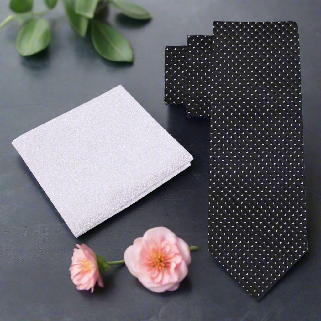 Elegant black silk tie featuring a geometric pattern, ideal for formal occasions.