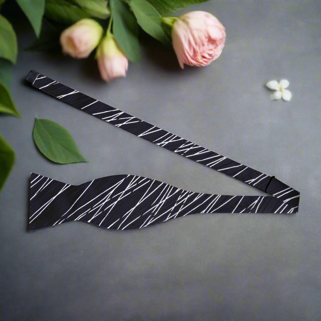 Close-up of brown abstract bow tie highlighting its intricate pattern and texture.