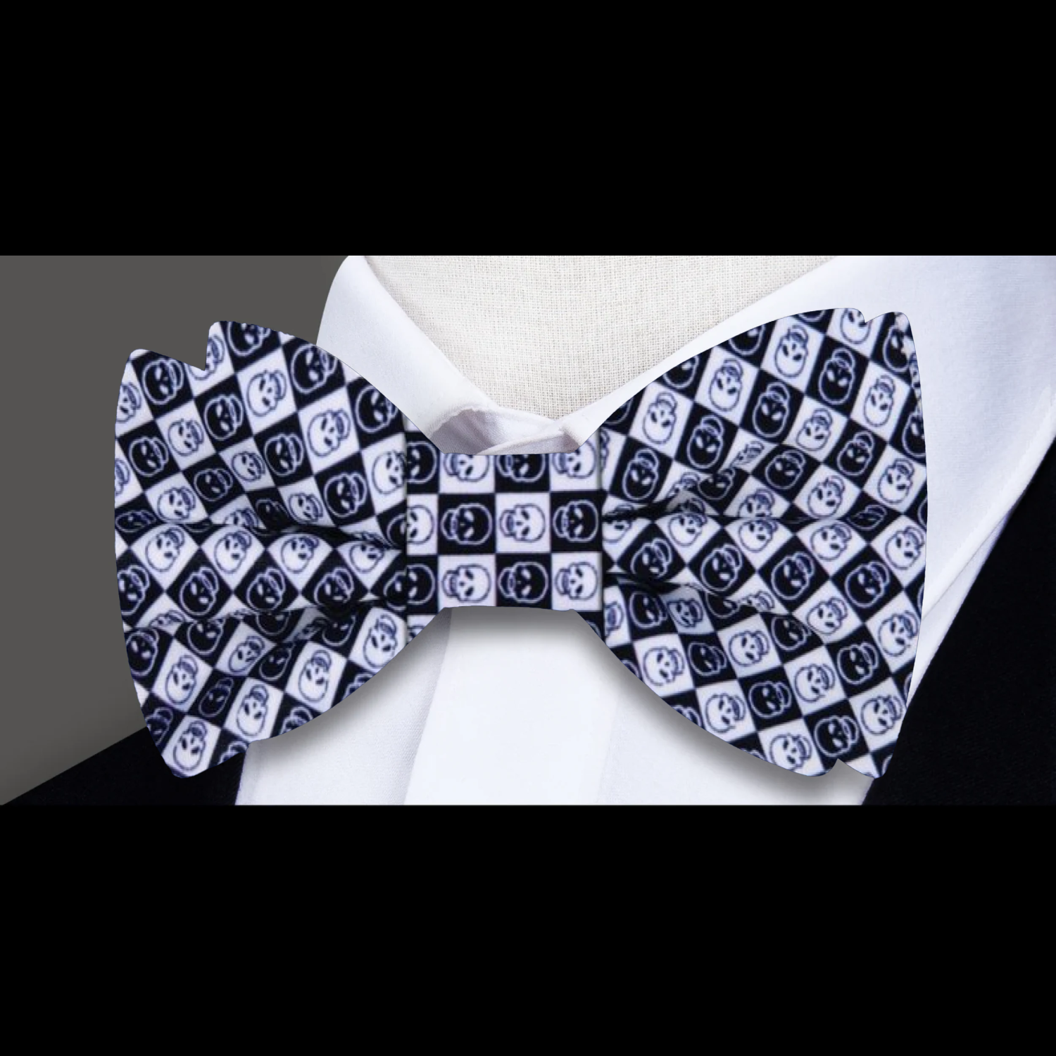 Close-up of the blue skull bow tie highlighting the intricate geometric design against a navy suit.