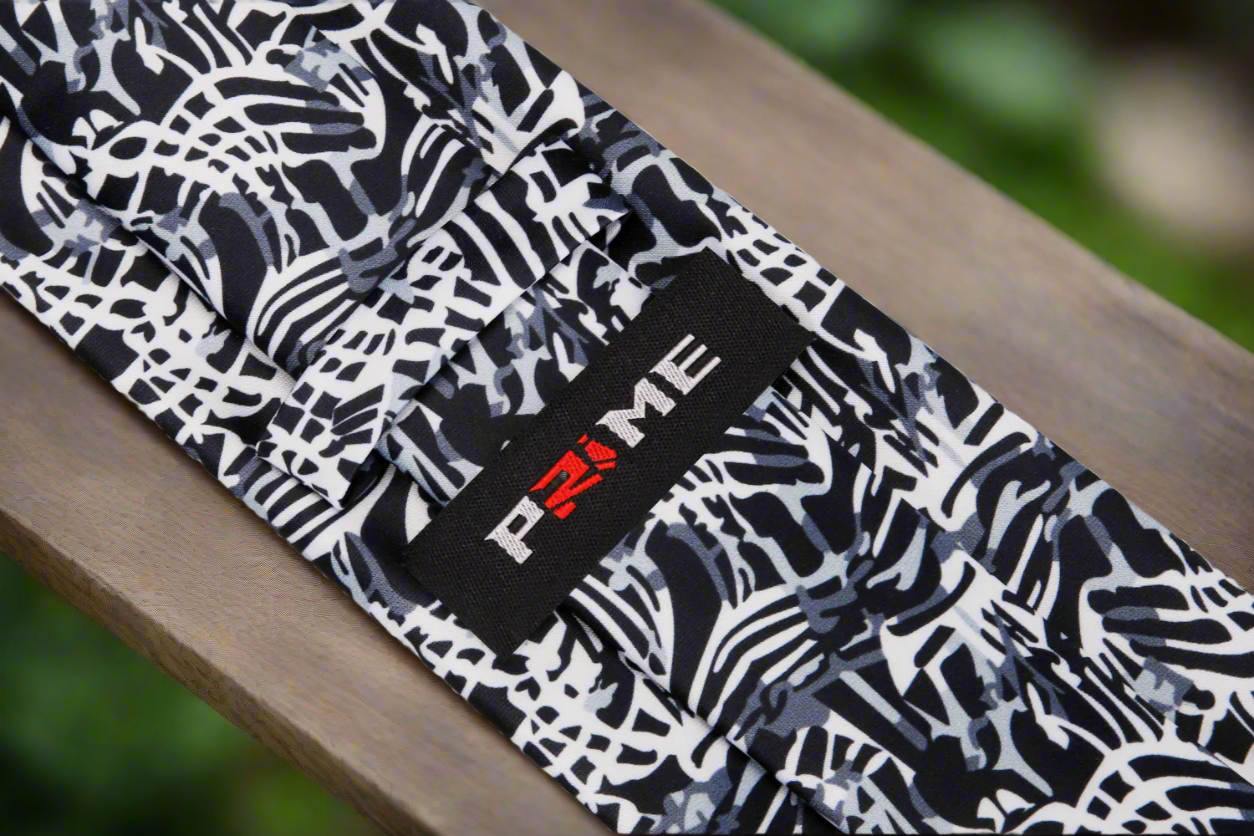 Silk tie displayed alongside a matching pocket square, showcasing modern design.