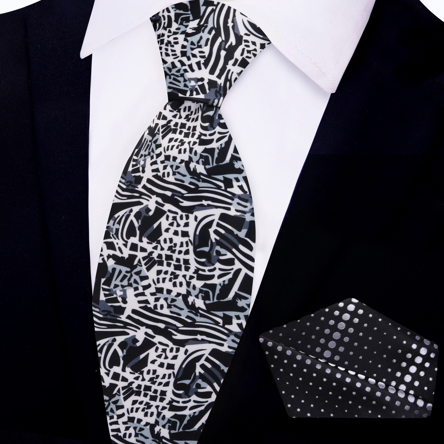 Silk tie displayed alongside a matching pocket square, showcasing modern design.
