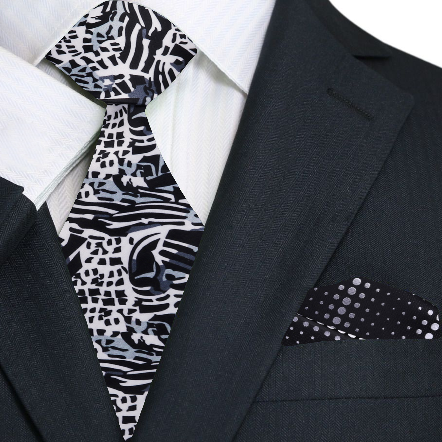 Man wearing the grey, white, and black abstract tie paired with a charcoal suit.