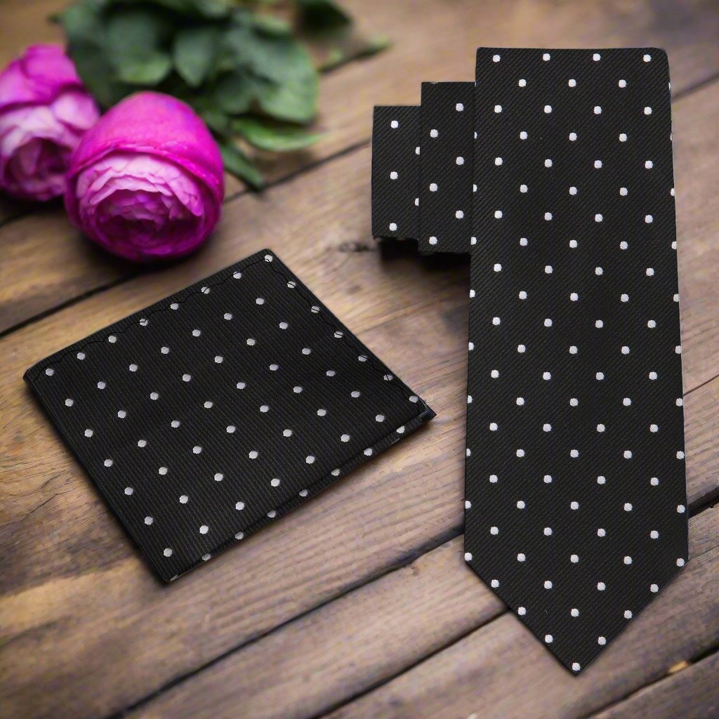 Close-up of a navy silk tie with white polka dots, ideal for formal occasions