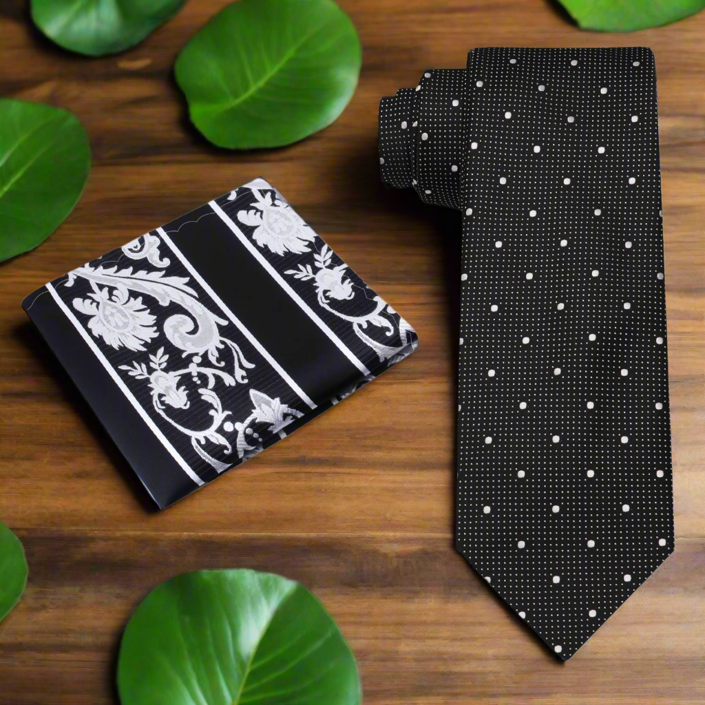 Close-up of black and white polka dot tie with subtle check texture, styled with a white dress shirt