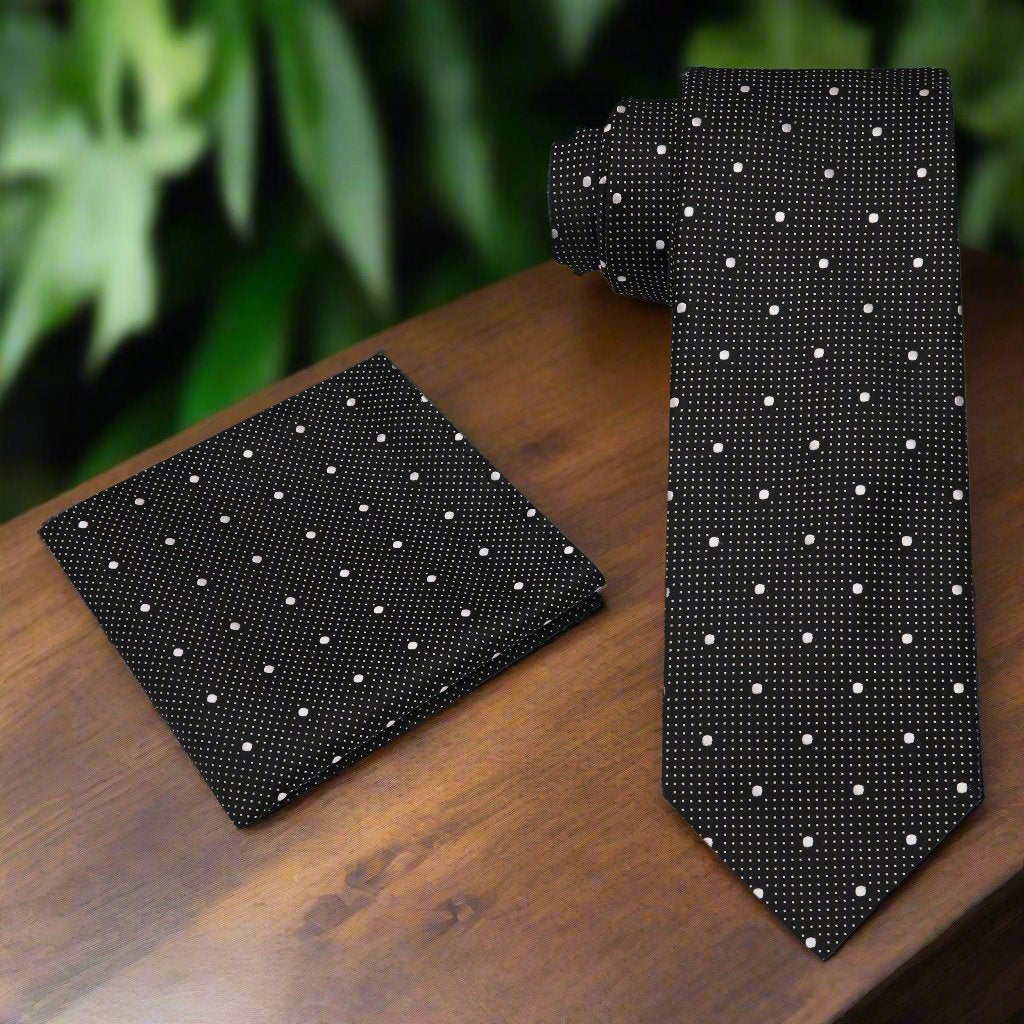 Black and red polka dot necktie displayed on a hanger, ideal for weddings or formal events