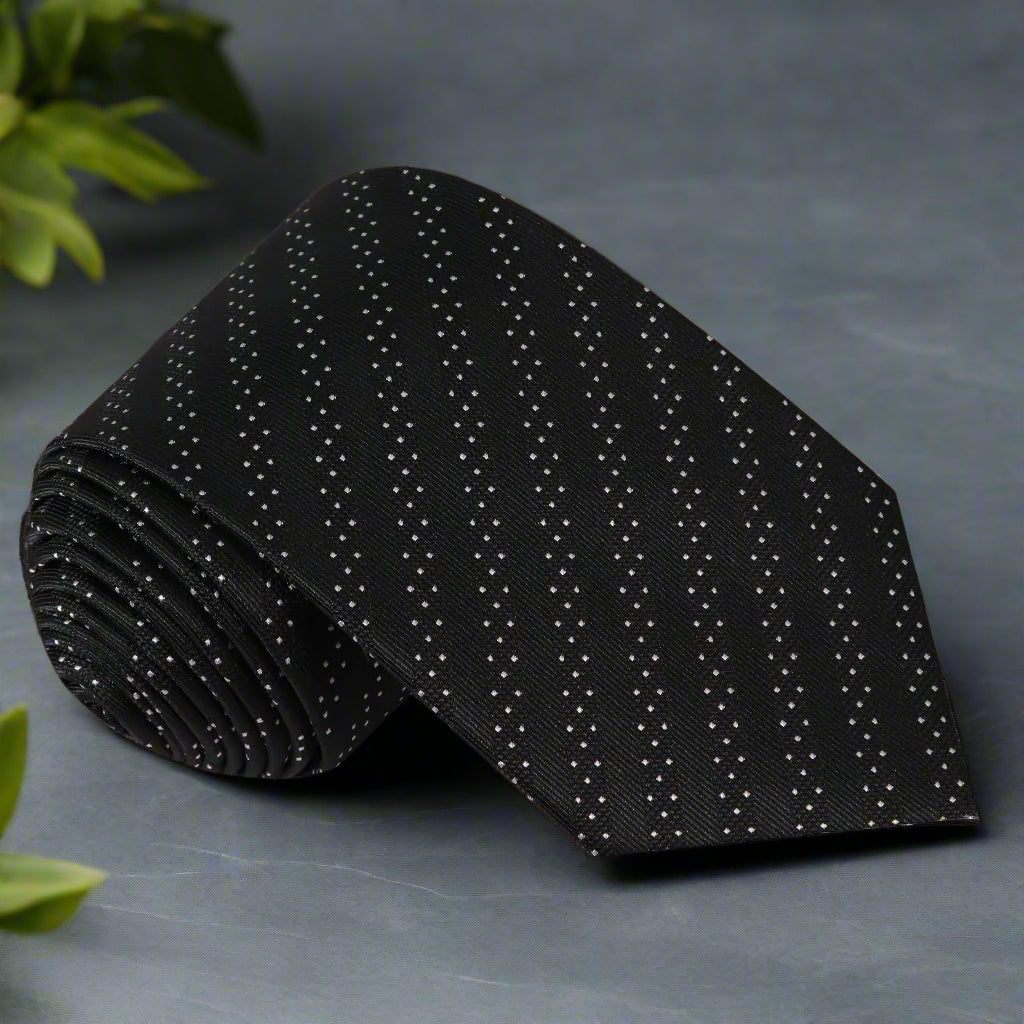 Close-up of black silk necktie with white dots and stripes for formal wear