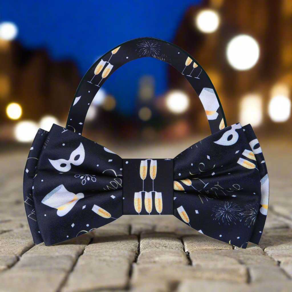 Close-up of champagne themed silk bow tie with festive motifs for New Year’s Eve