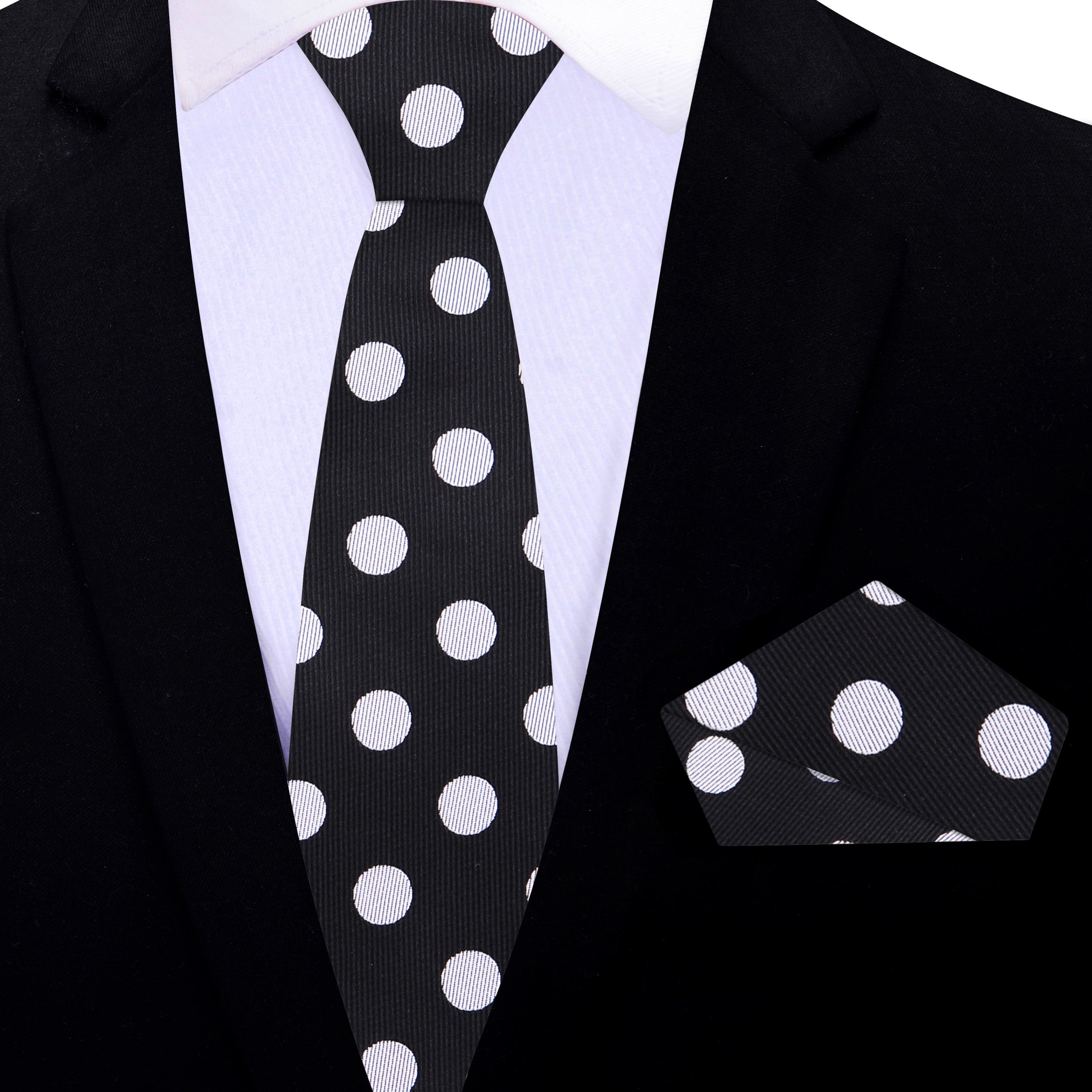 Fashionable polka dot tie paired with a grey suit for a sophisticated look