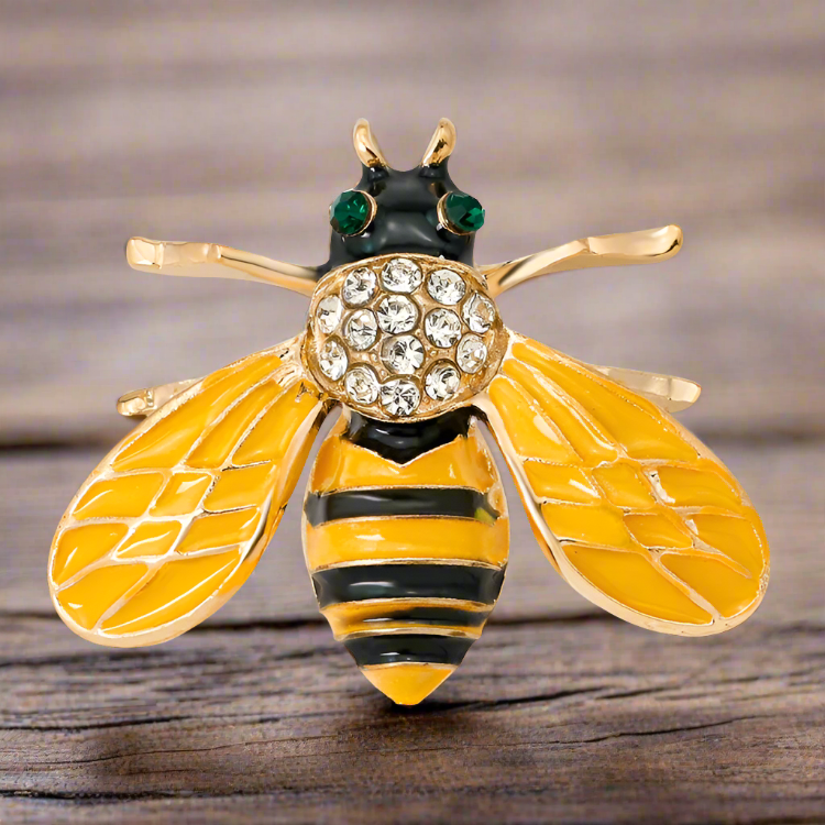 Different variations of the honey bee lapel pin including gold and pearl designs