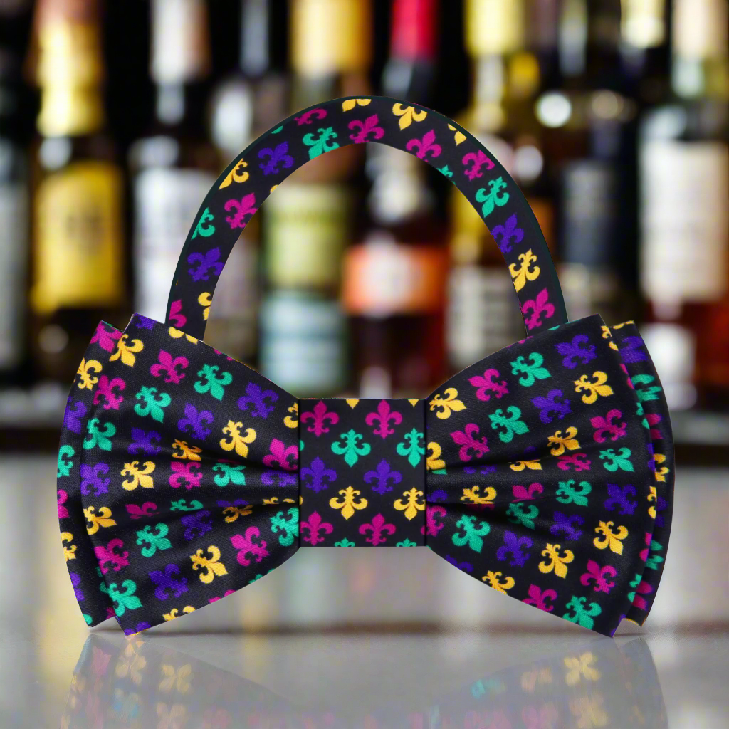 Close-up of the elegant fleur-de-lis pattern on a silk bow tie.