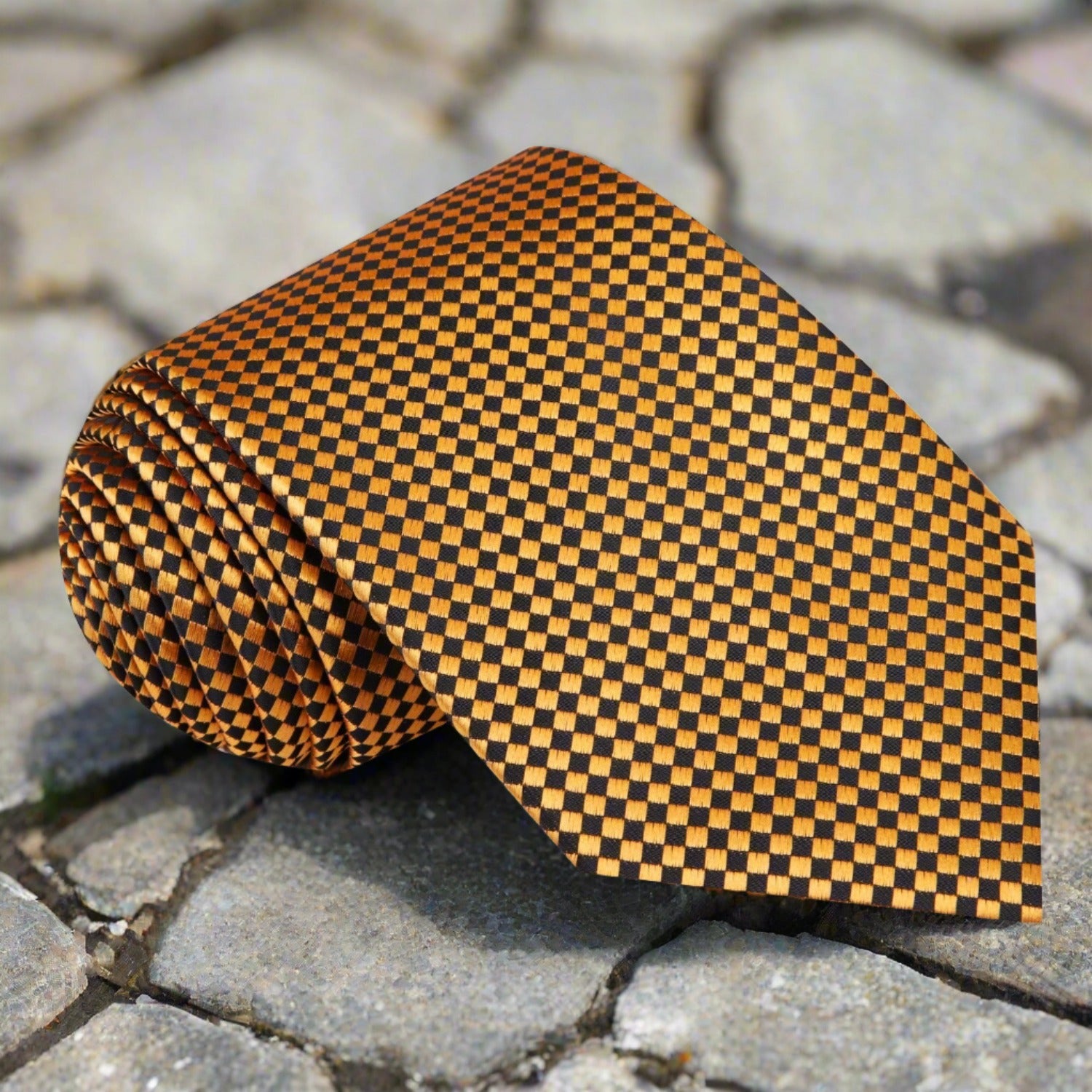 Close-up of the Noble Gold and Black Geometric Necktie showcasing its intricate diamond pattern.