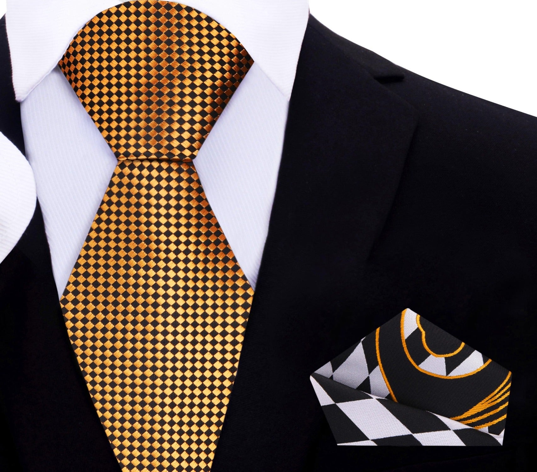 Flat lay of the Noble Gold and Black Geometric Necktie alongside a charcoal grey suit and dress shoes.