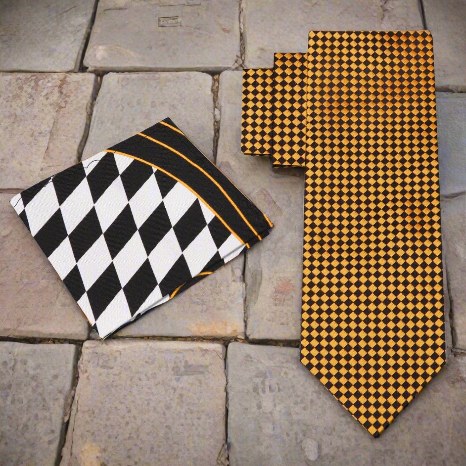 Model wearing the Noble Gold and Black Geometric Necktie with a white dress shirt at a formal event.