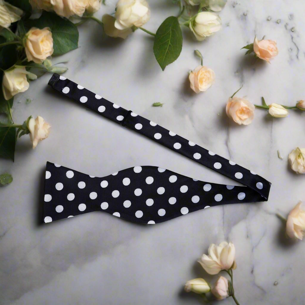 Polka dot bow tie worn with a navy suit, perfect for weddings and formal events.