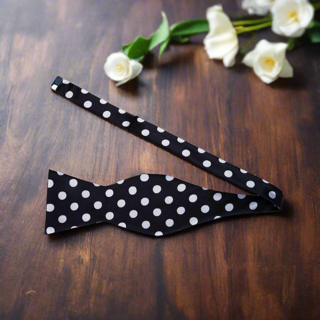 Formal silk bow tie and pocket square set displayed flat with packaging