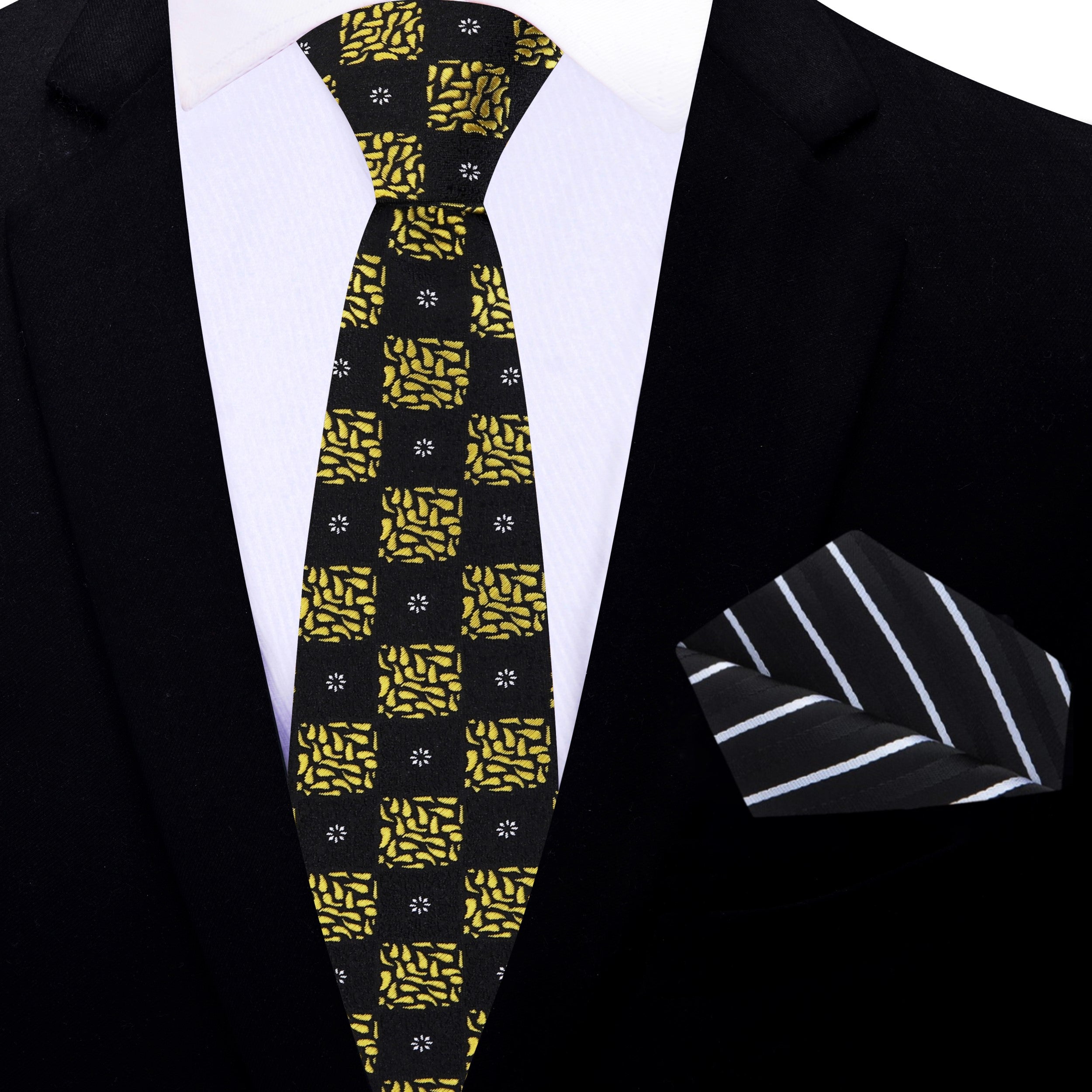Detail shot of the black and gold geometric pattern on the luxury necktie, highlighting craftsmanship