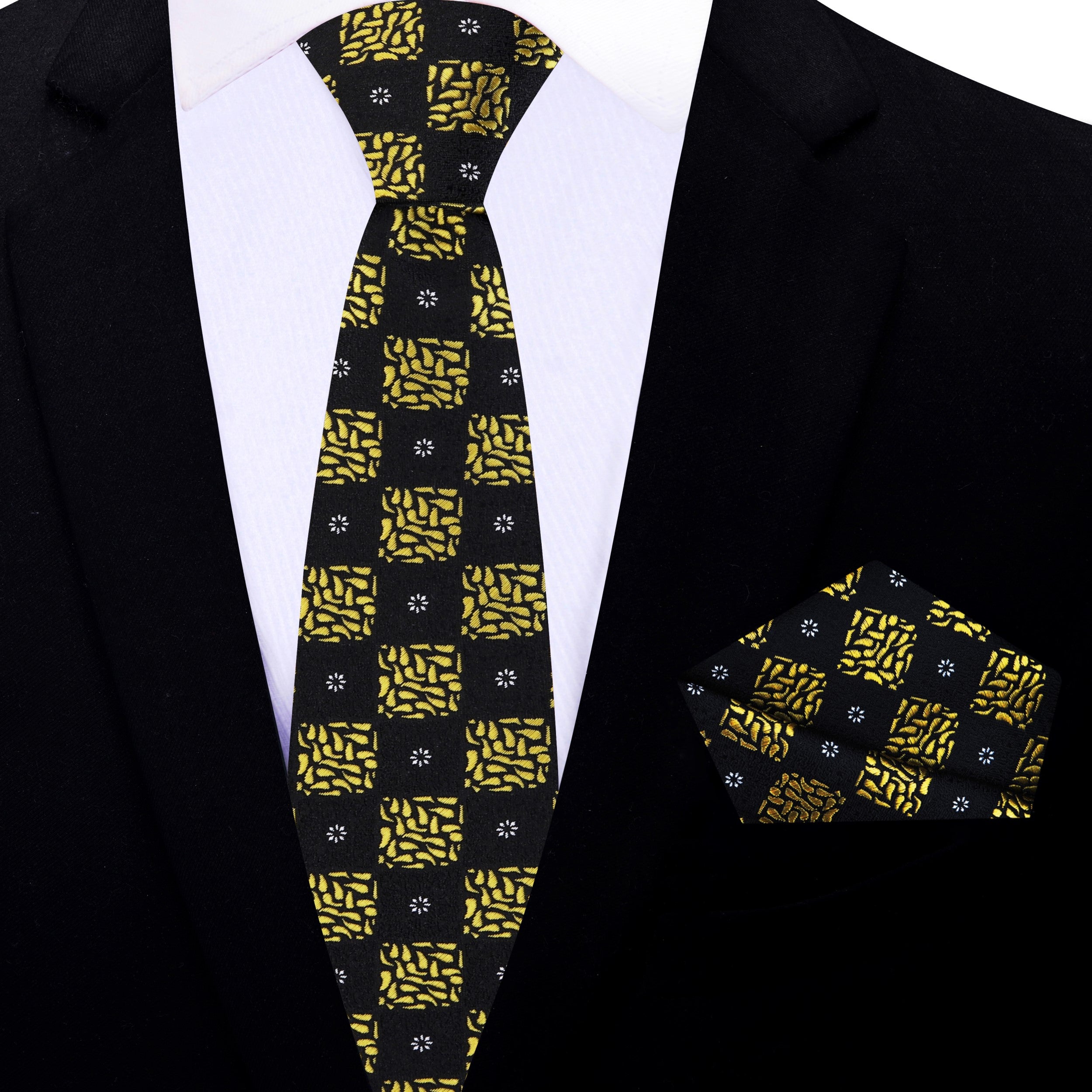 Detail shot of the black and gold geometric pattern on the luxury necktie, highlighting craftsmanship