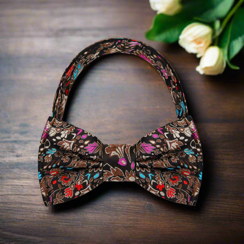 Elegant brown floral bow tie on a model wearing a dark suit at an outdoor event