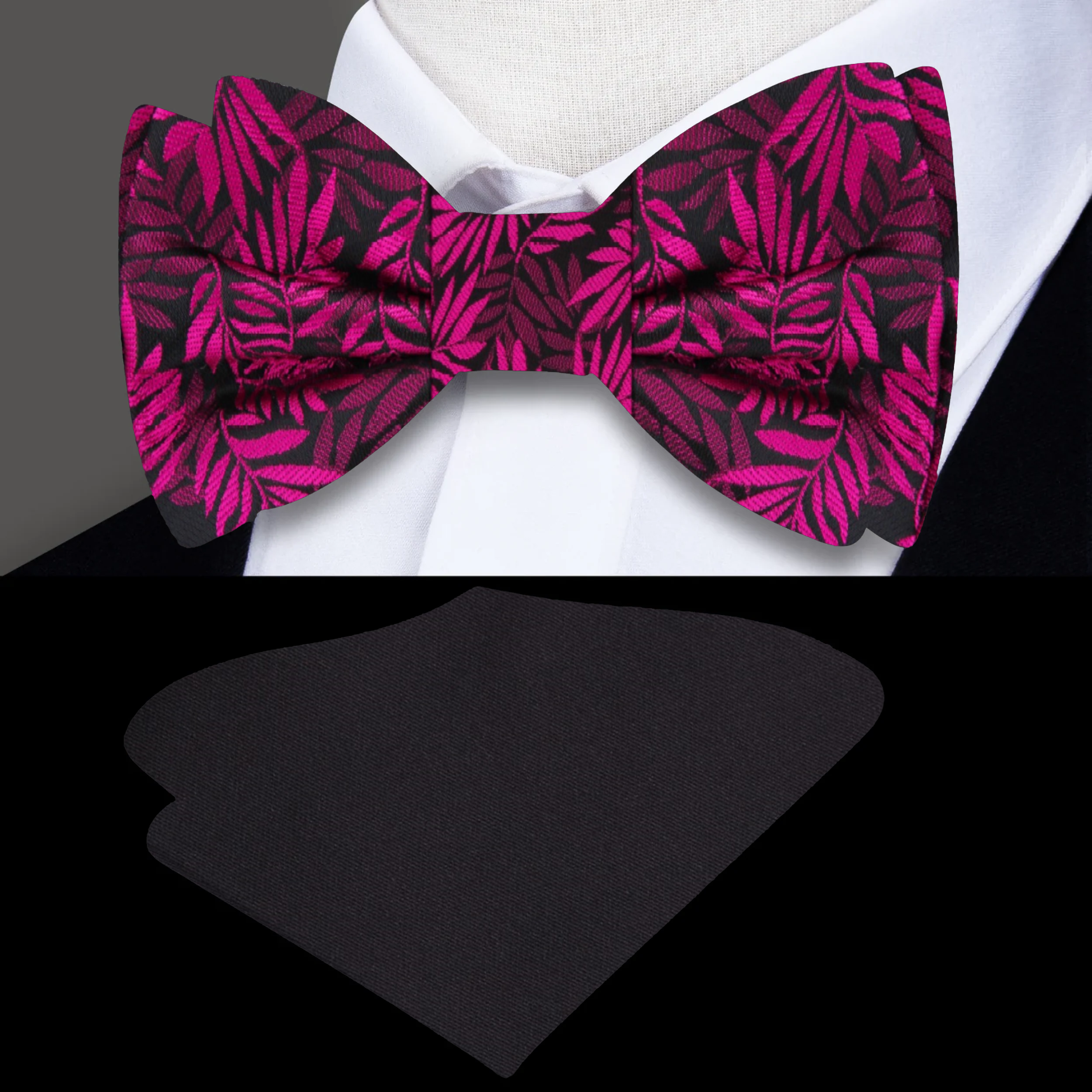 Close-up of black silk bow tie with pink leaves pattern, ideal for formal wear