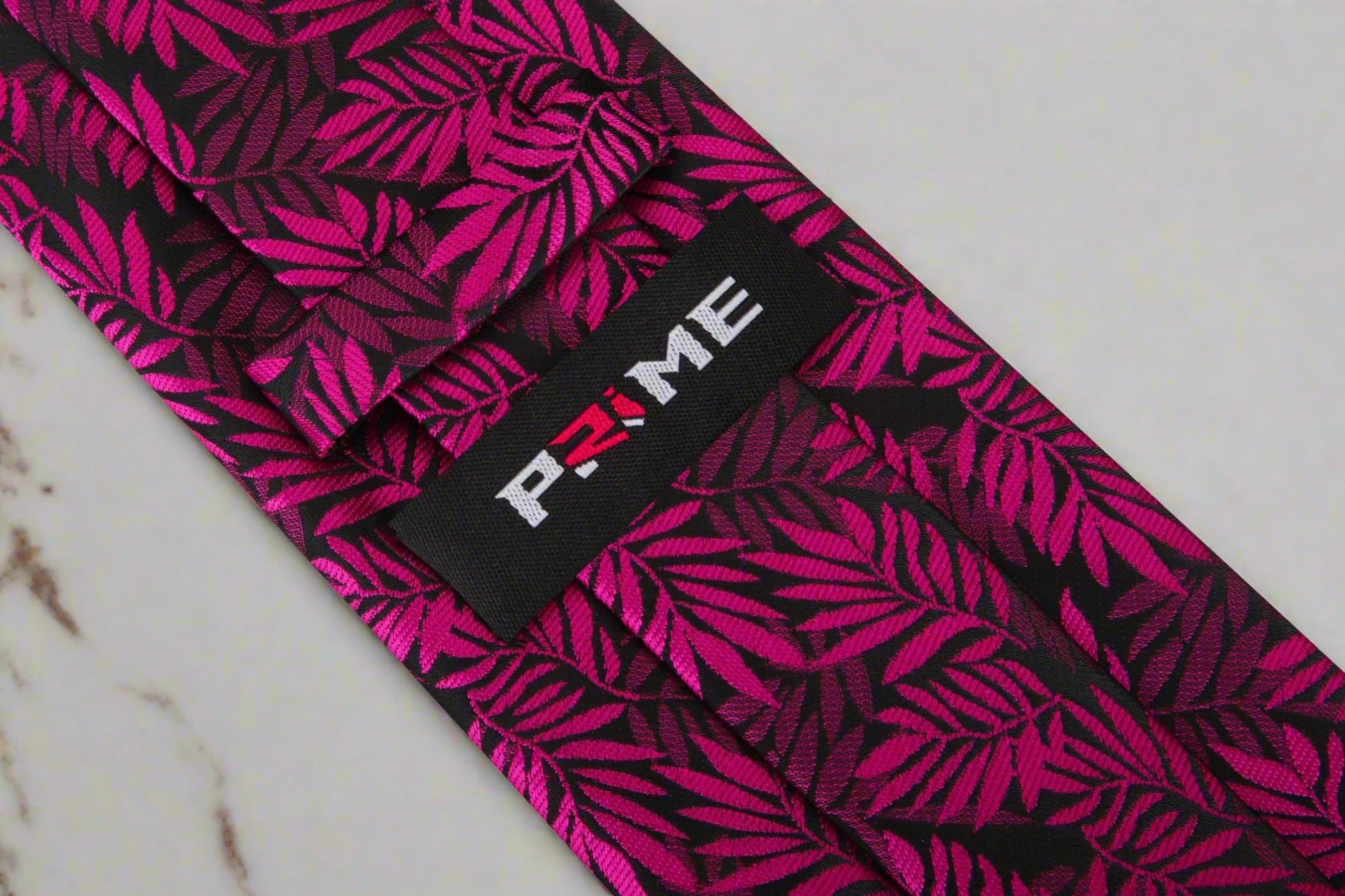 Silk necktie with red, pink, and black leaves pattern for weddings and formal events
