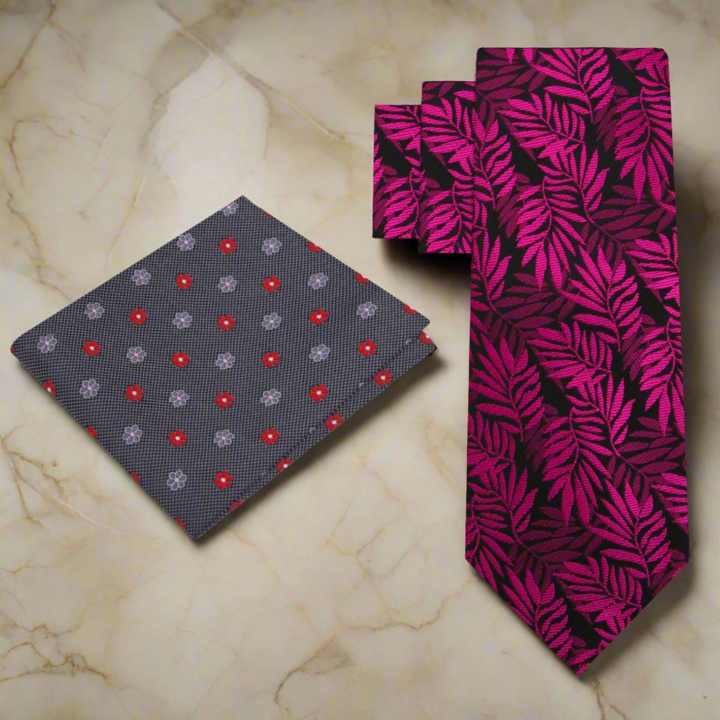 Close-up of a patterned silk tie in shades of red and pink, suitable for dressy occasions