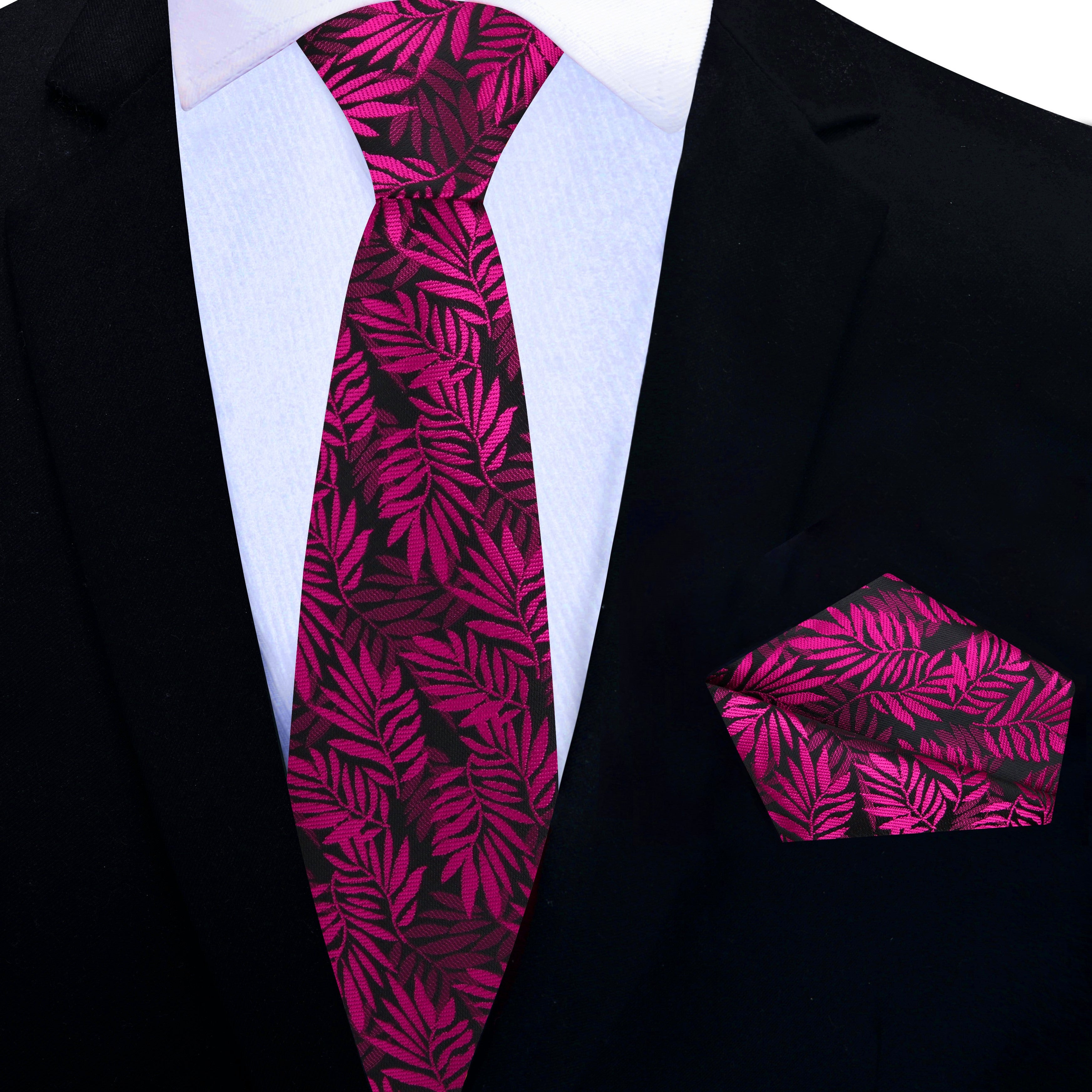 Close-up of a patterned silk tie in shades of red and pink, suitable for dressy occasions