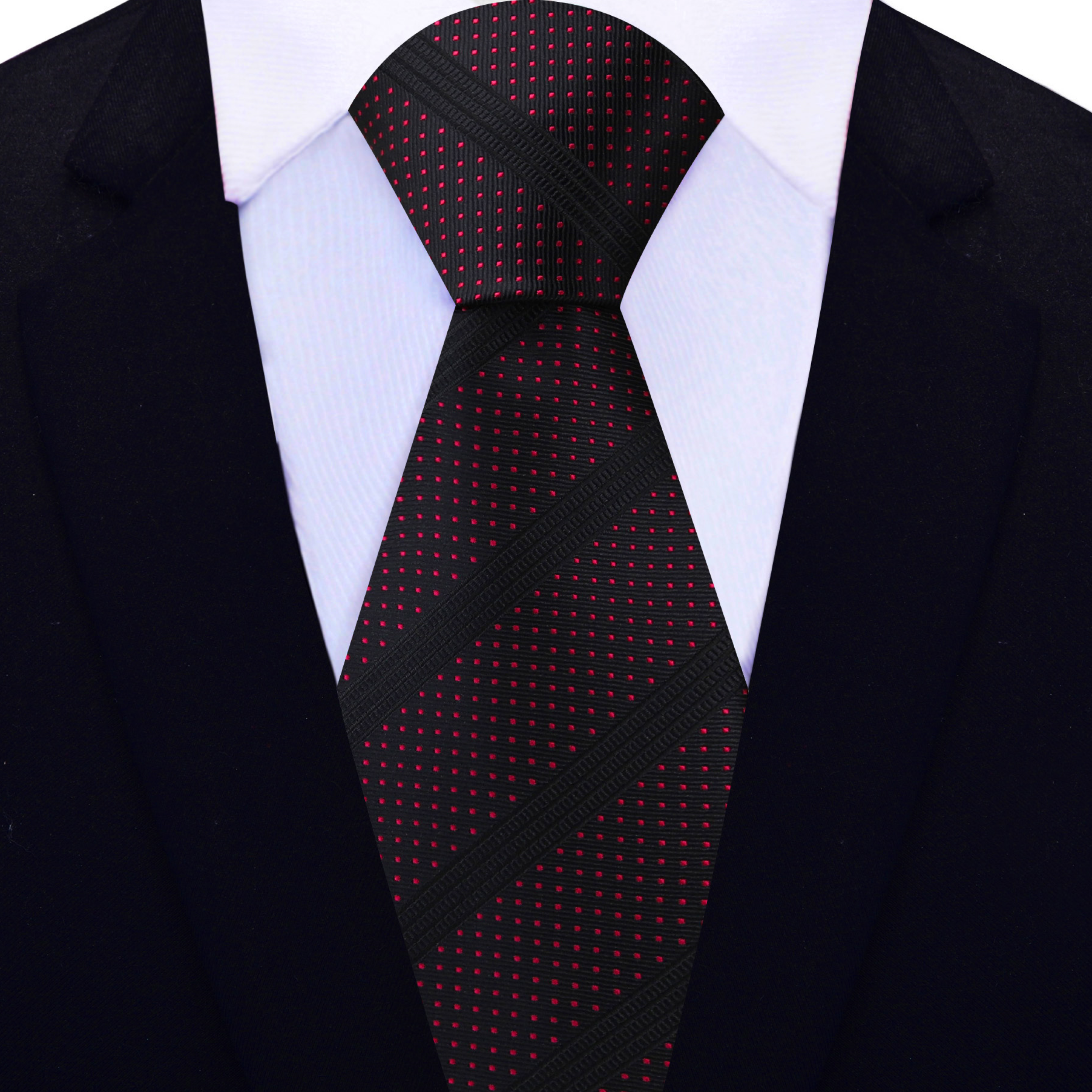 Elegant black silk necktie with red dots displayed on a grey suit.