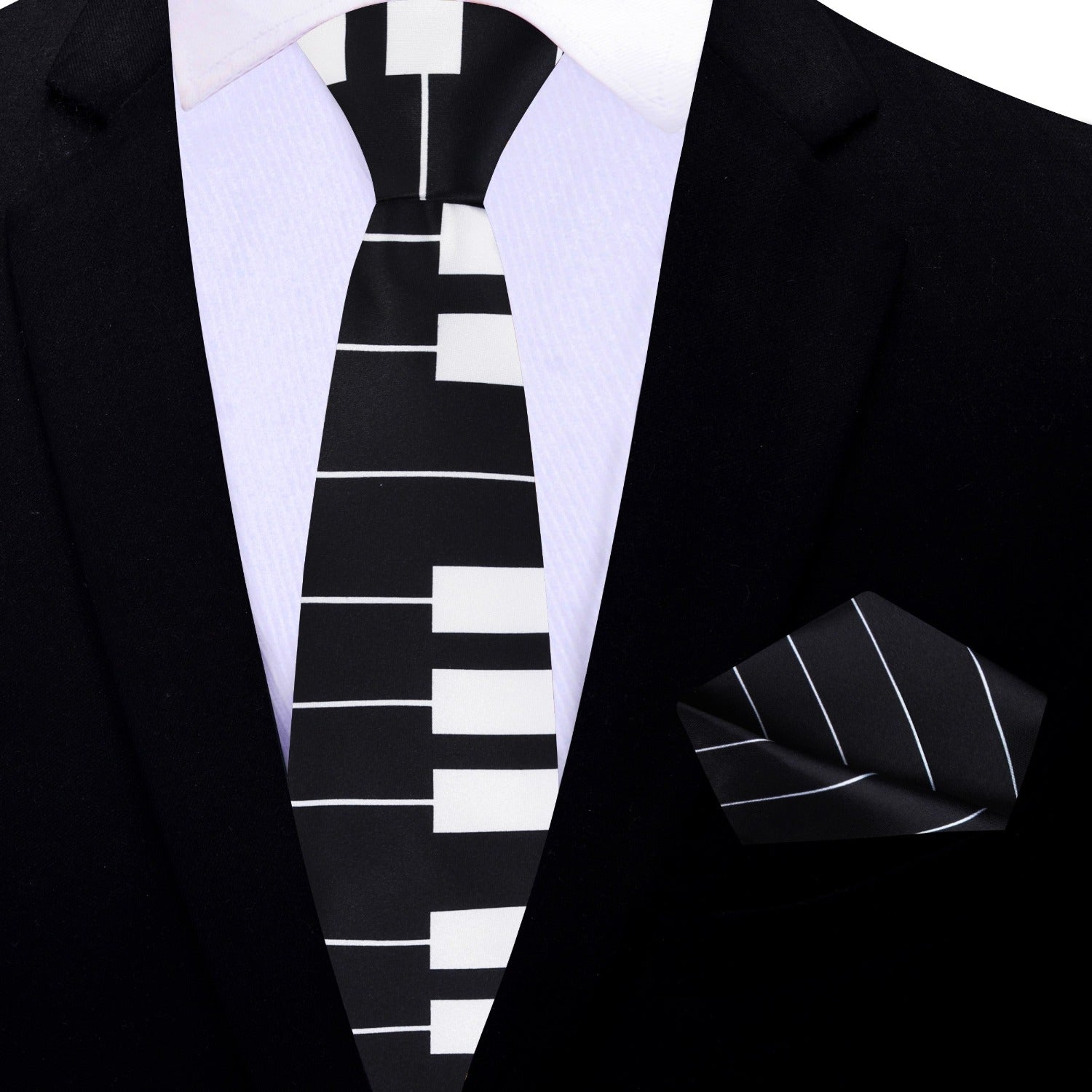 Man wearing stylish black and white piano tie with suit at a concert
