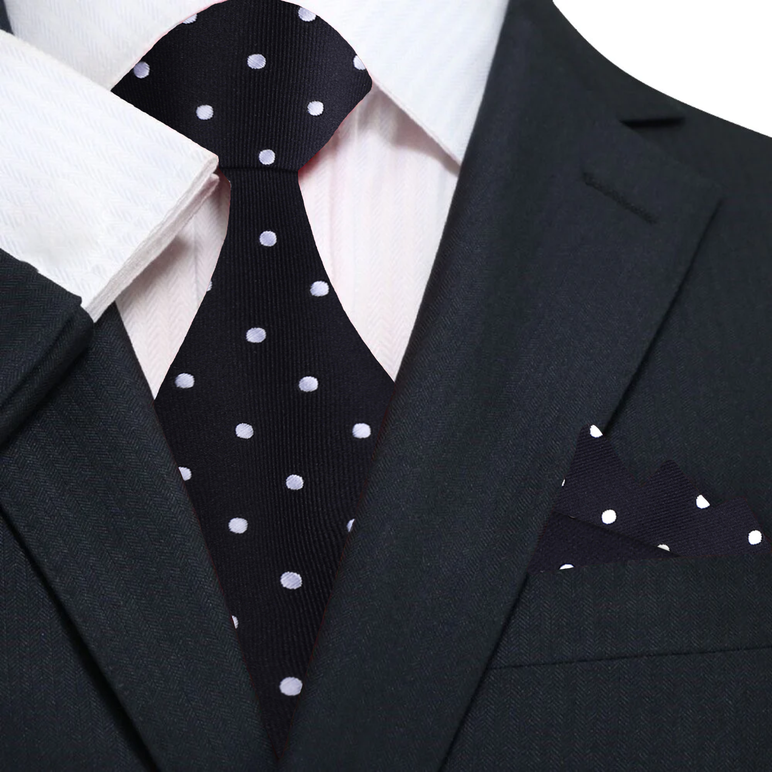 Man wearing a stylish polka dot silk tie with a navy suit at a formal event