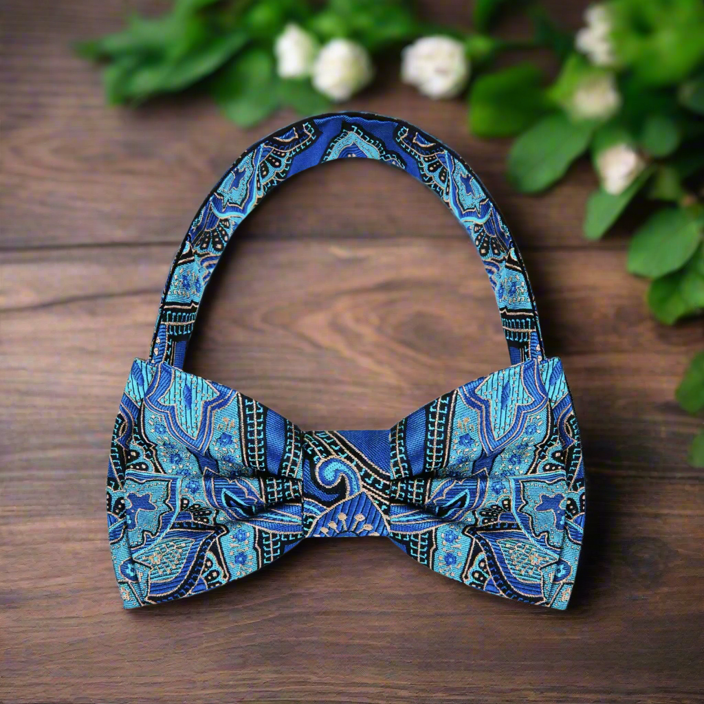 Teal paisley bow tie paired with a charcoal grey suit, emphasizing its stylish appeal for evening events.