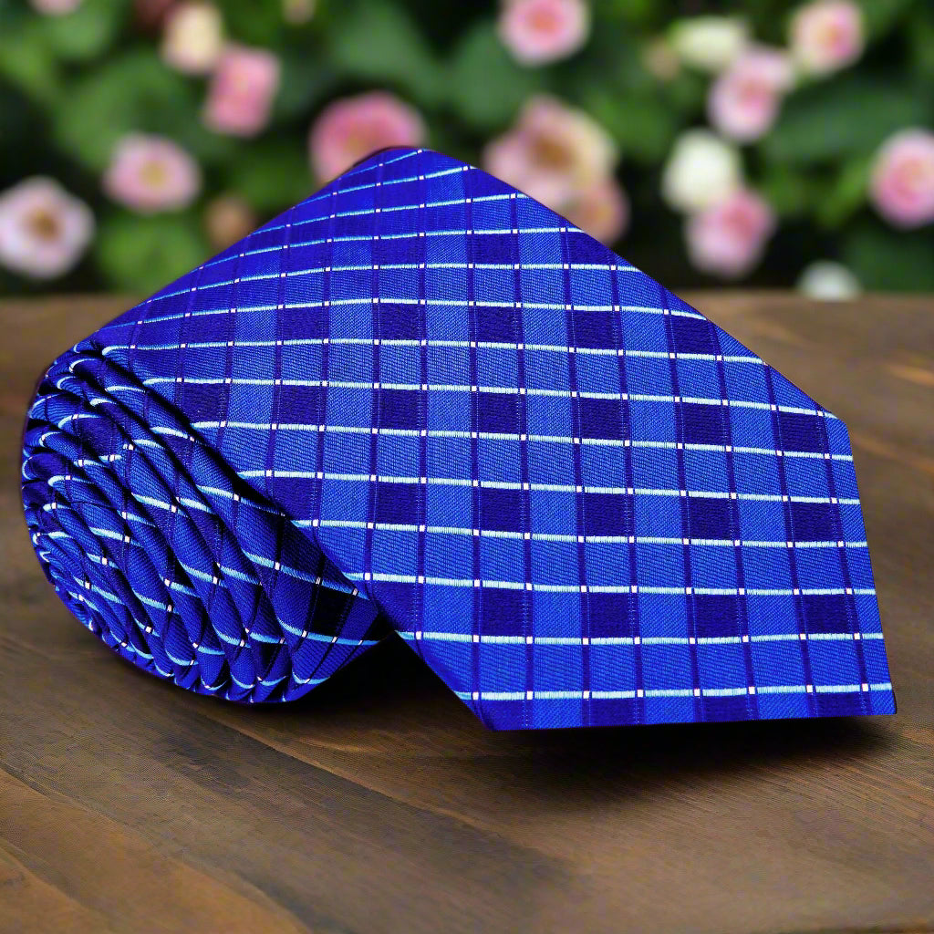 Close-up view of blue geometric necktie showcasing intricate pattern.