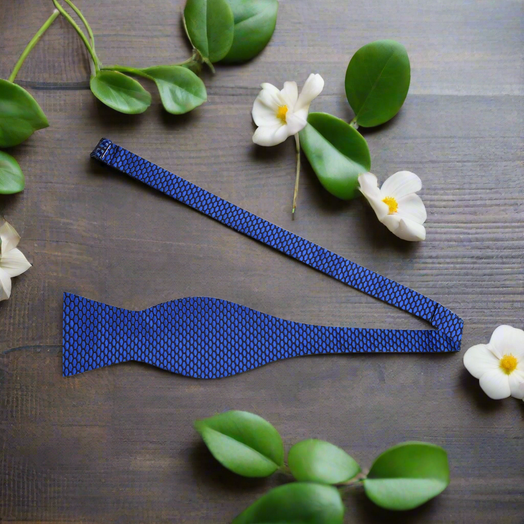 Front view of a geometric pattern silk self-tie bow tie in grape purple