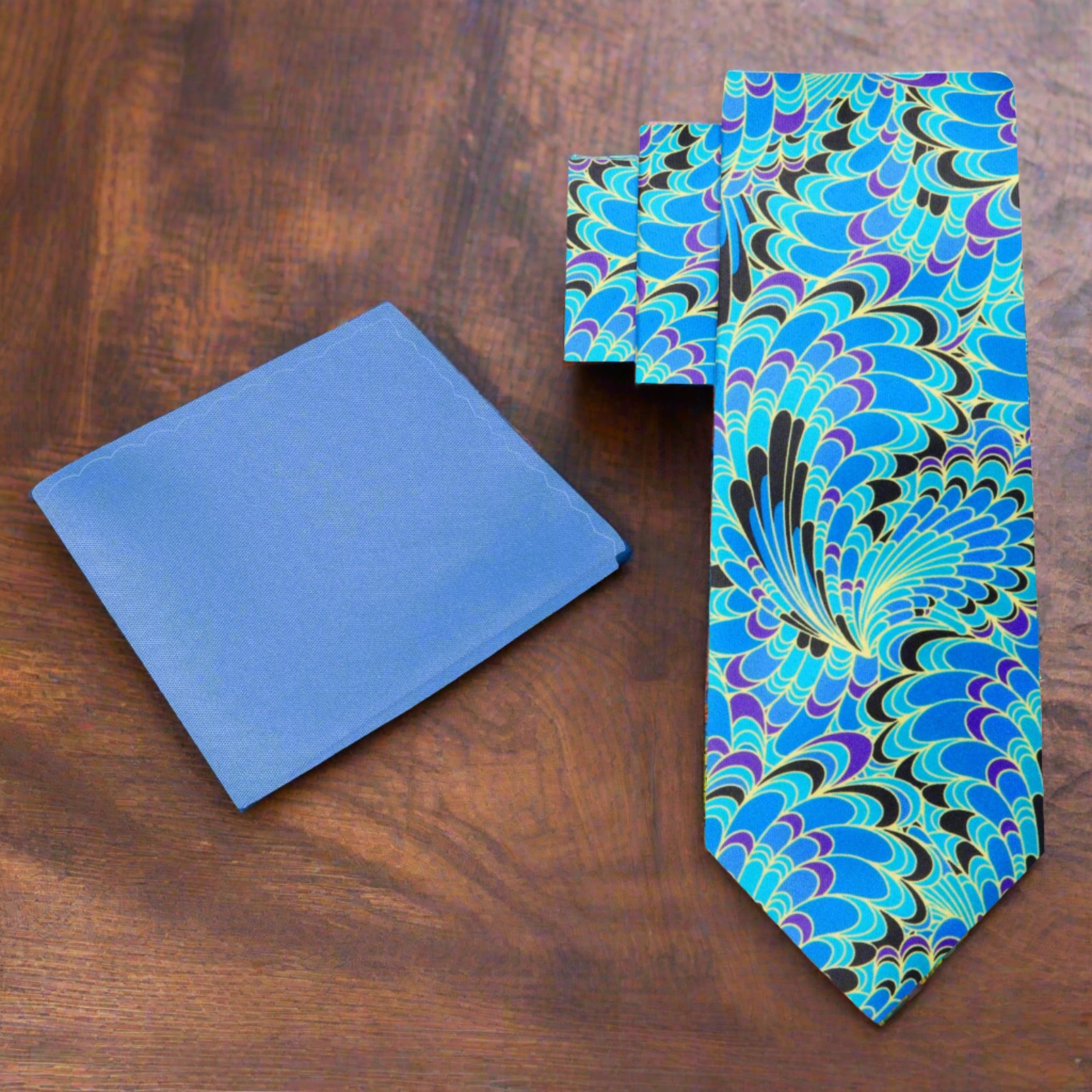 Close-up of the detailed peacock feather pattern on a stylish silk necktie