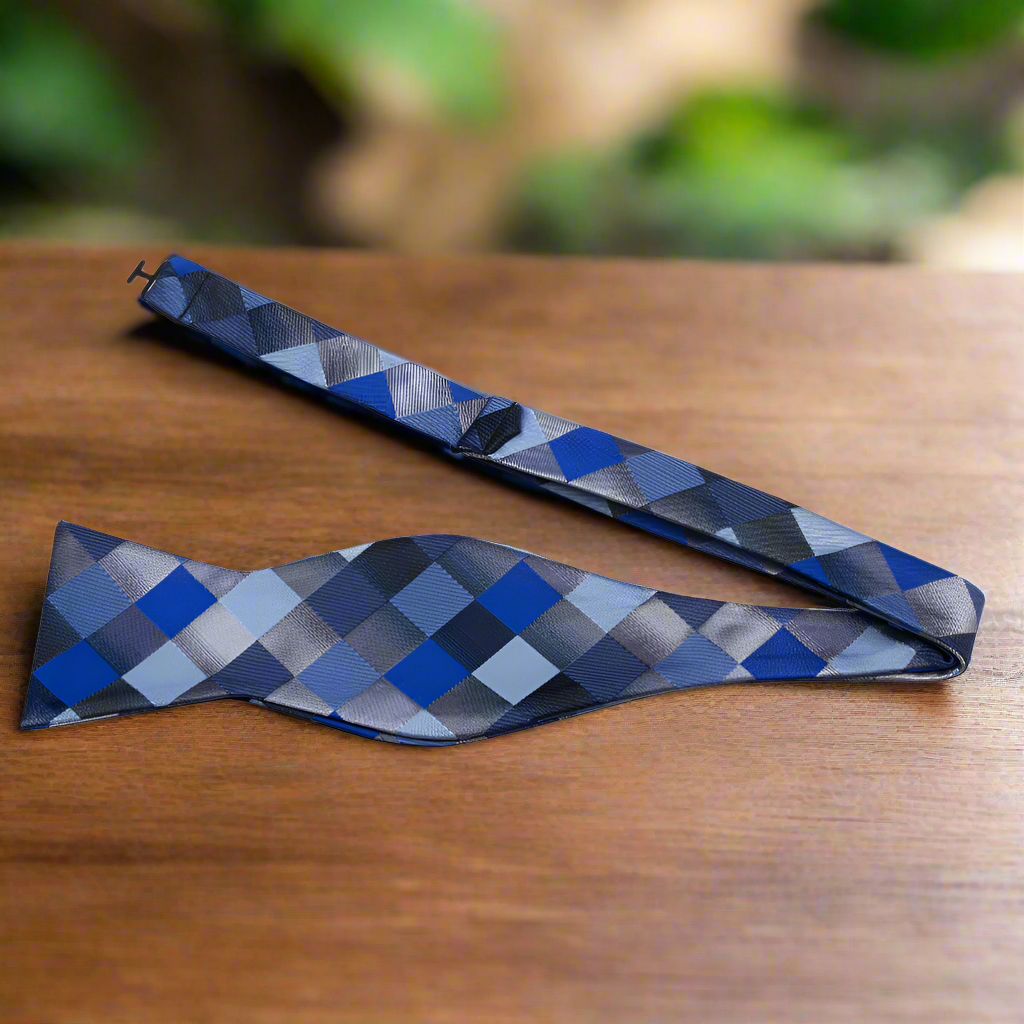 Model wearing a stylish geometric silk bow tie with a navy suit for a business meeting