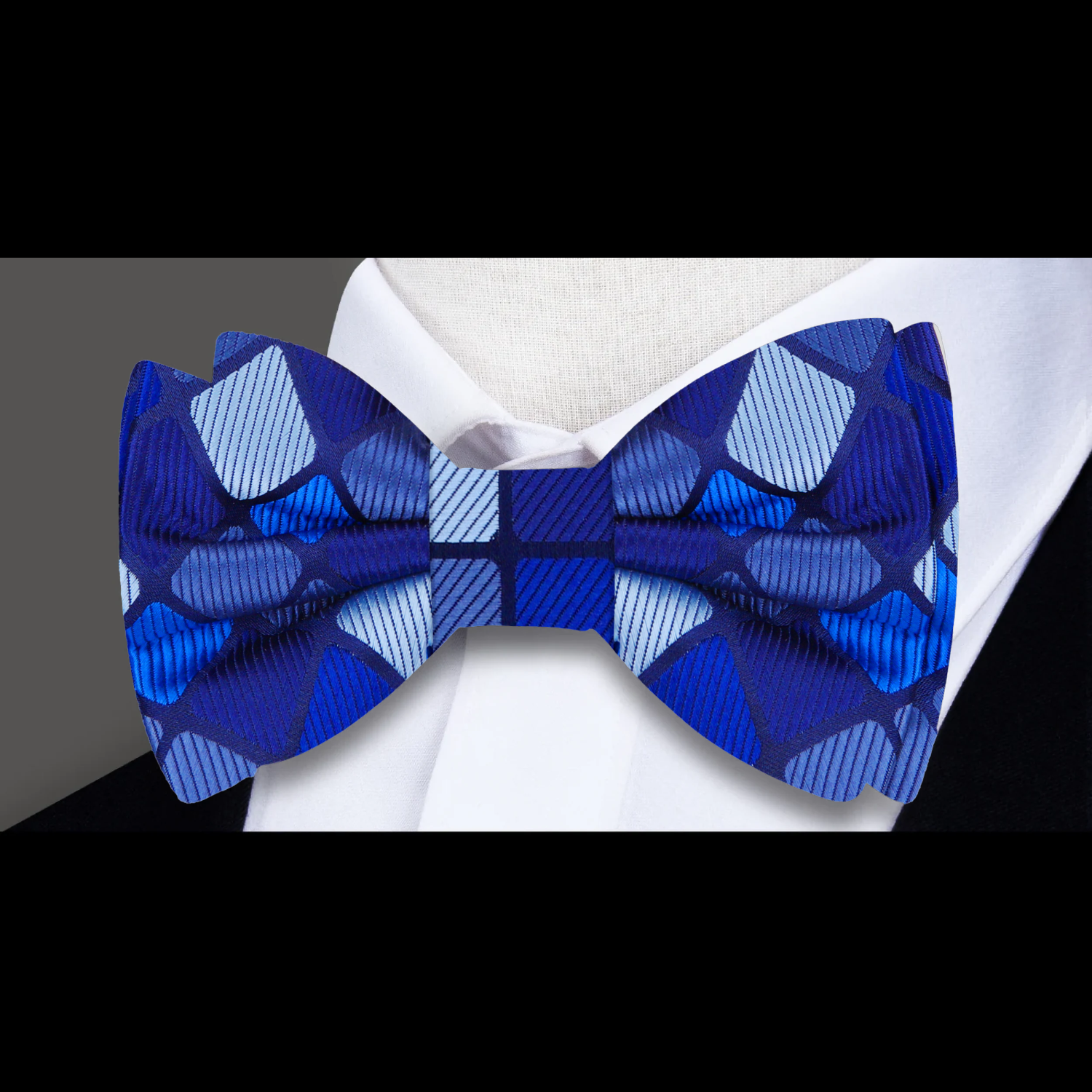 Close-up of the stylish blue self-tie bow tie showcasing the geometric design.