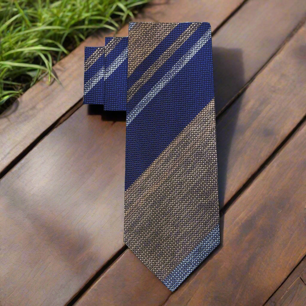 Front view of striped tie showcasing silk texture and blend of grey, blue, and brown tones.