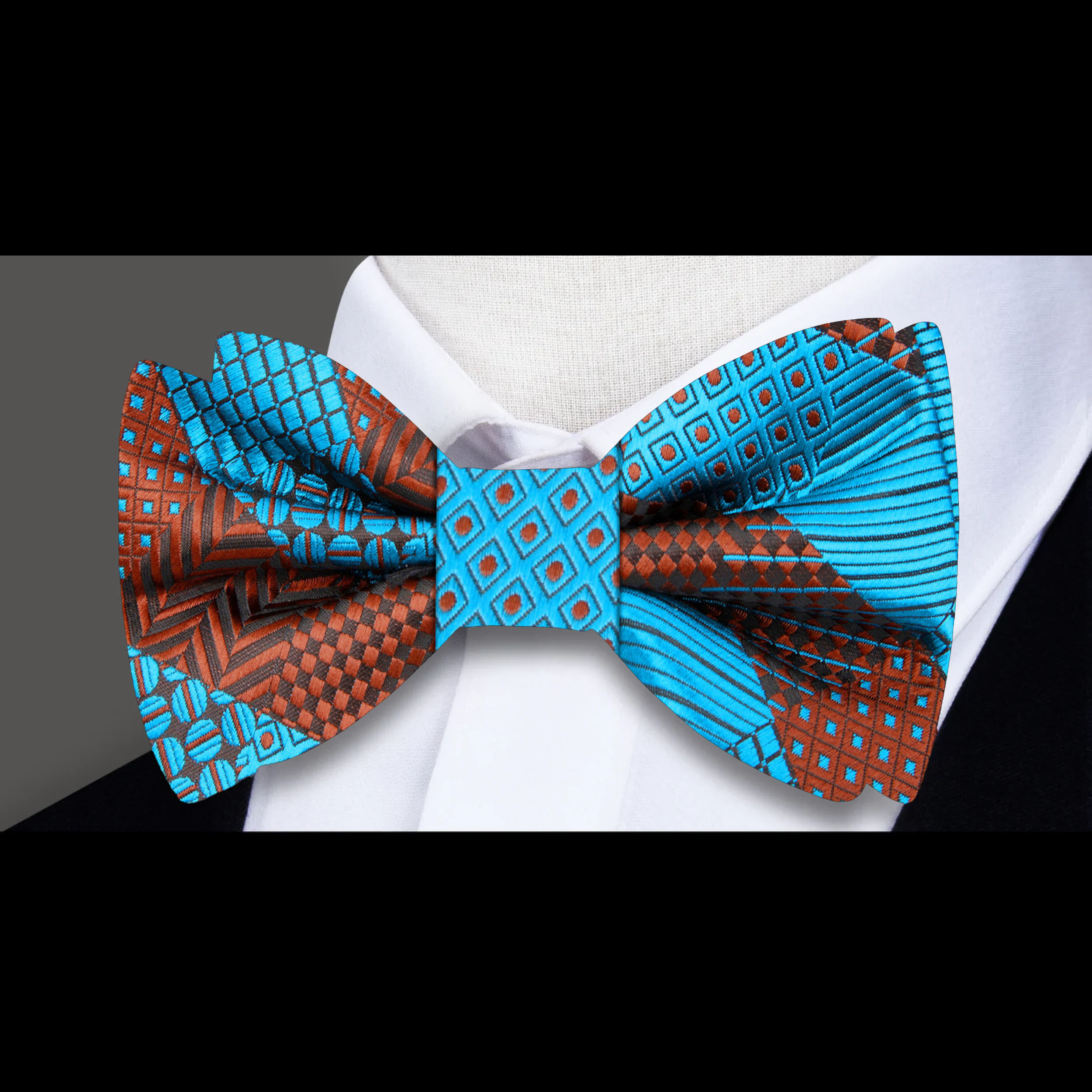 Close-up of a blue geometric silk bow tie on a model for wedding attire